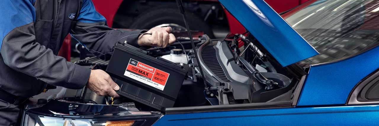 close up view of Ford technician changing a car battery