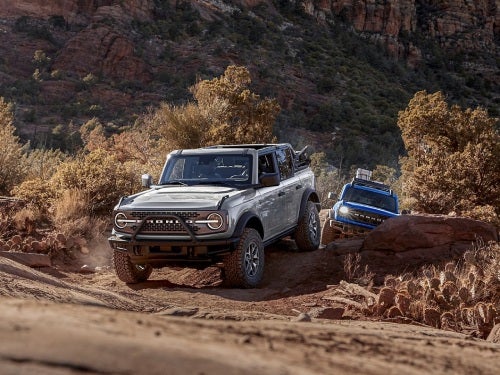 2024 Ford Bronco driving along a rocky dirt path