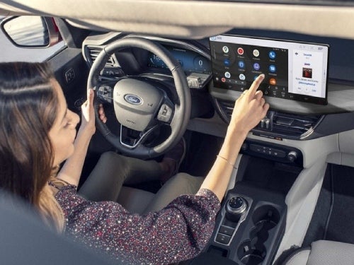 2024 Ford Escape Plug-in Hybrid close up view of woman using touchscreen 