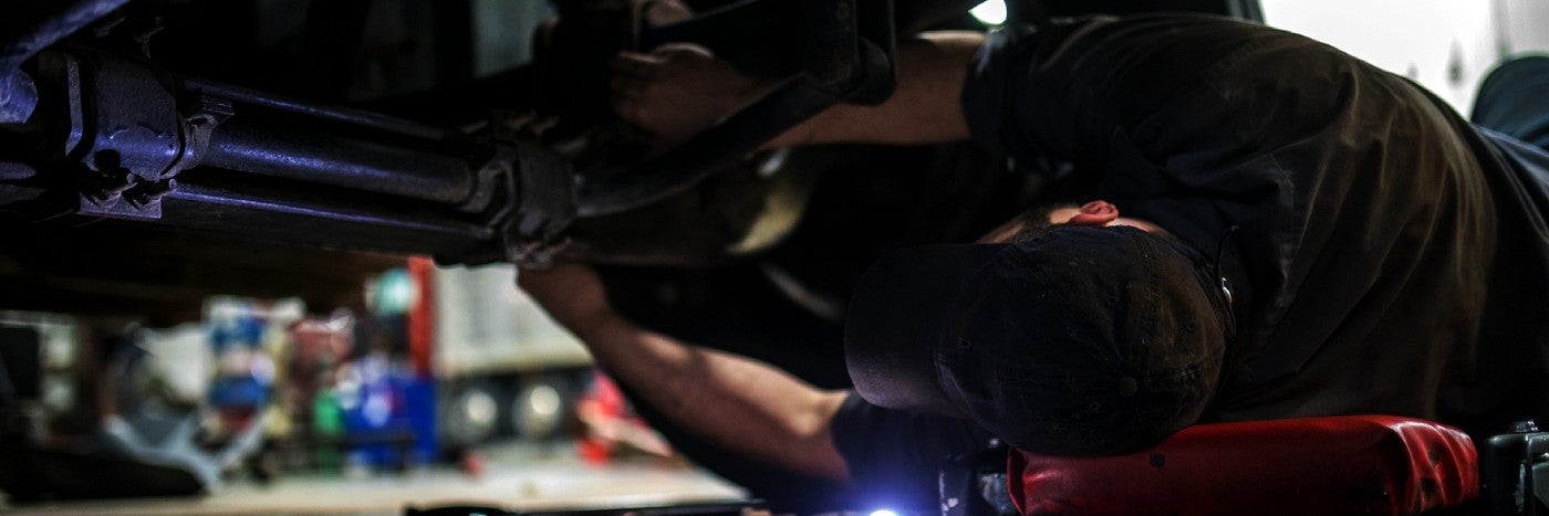 close up view of a vehicle's driveline being serviced